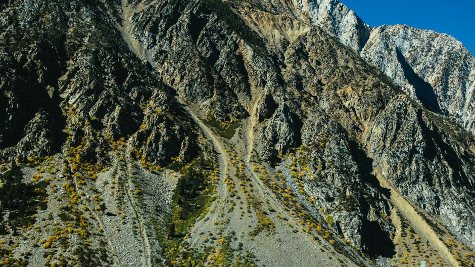 Stunning view of a rocky mountain landscape with distinctive geological formations under a clear blue sky.