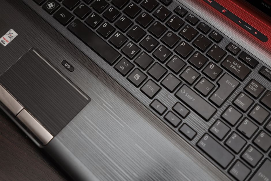 Detailed top view of a laptop keyboard and touchpad, ideal for technology themes.